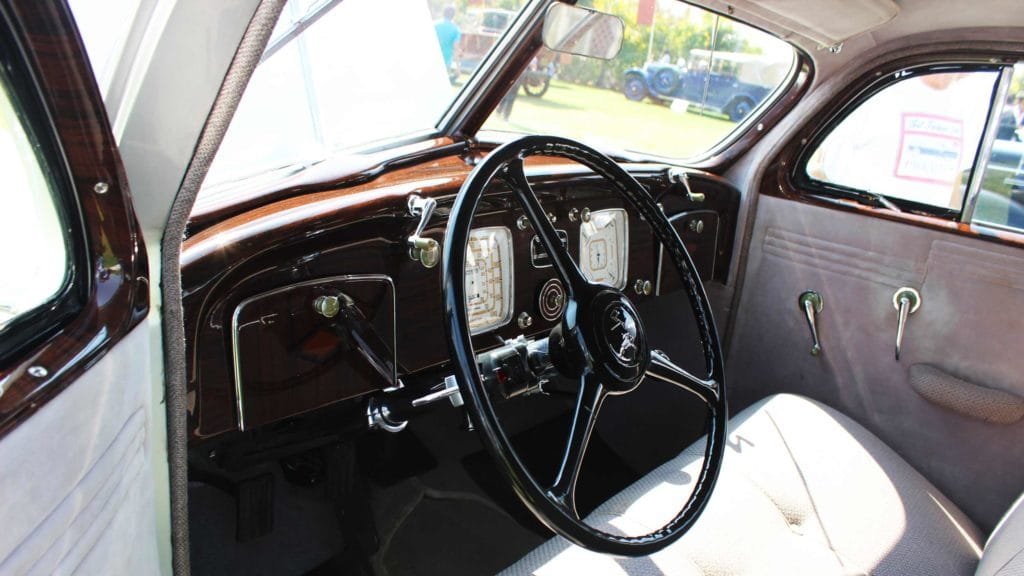 Streamlined handles, fine wooden inlays and bold patterns on the dash gauges, Photo Credit: Karl Bhote