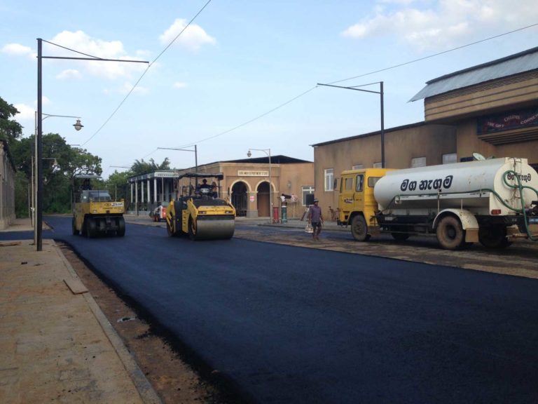 Work in progress in Sri Lanka where road rollers level out newly laid streets alongside freshly fabricated buildings for the film. Photo Courtesy: Dhara Jain
