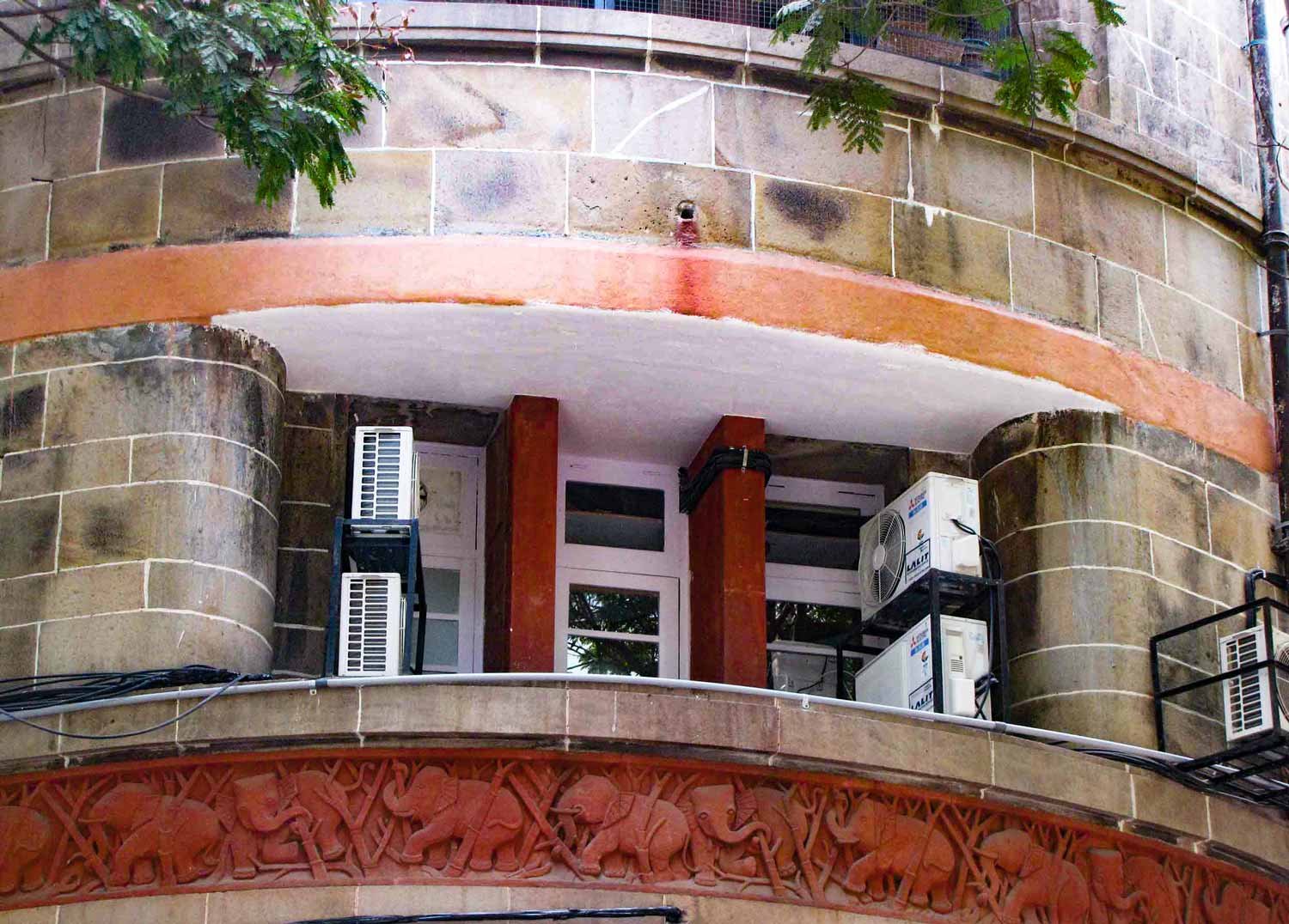 Façade of Lakshmi Building with chhajas and carved elephants on red sandstone panels. Master, Sathe & Bhuta. 1936–1938. Bombay, India. Source: Art Deco Mumbai