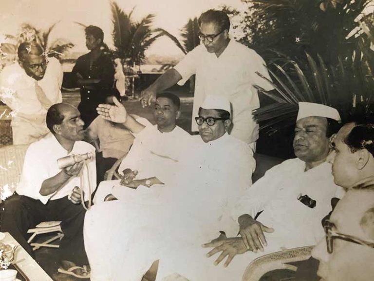 At his Bandra home and studio, Pansare is seated in the far-left corner holding the binocular. You also see him passing a binocular over to so that everyone can use it to view the whole statue of Chhatrapati Shivaji Maharaj; Source: Pansare Family Archive
