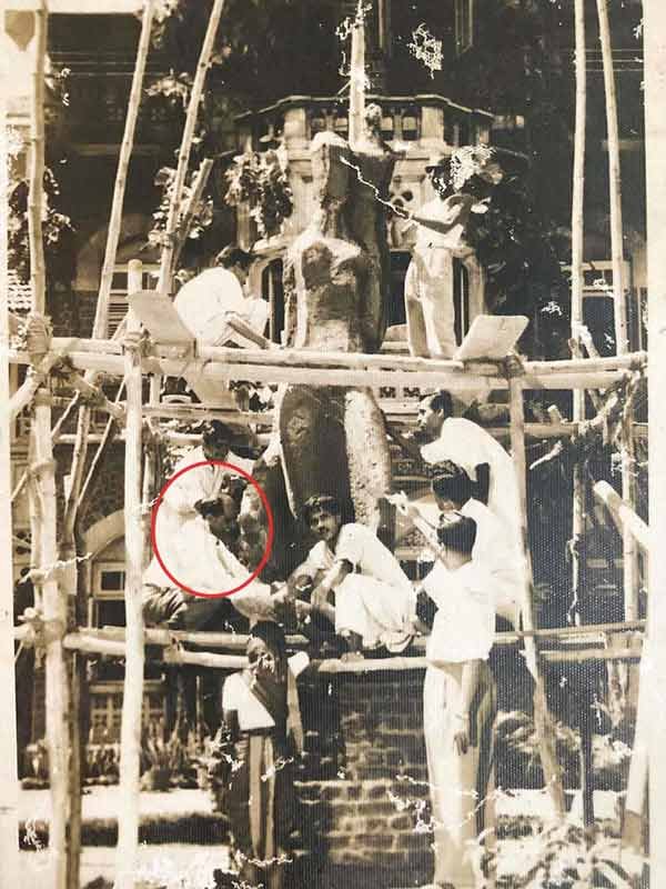 The before completion picture of the J.J. School of Art installation by Pansare. Seen (in circle - dark trousers and light shirt) kneeling at the first level of scaffolding in the lower-left corner; Source: Pansare Family Archive